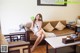 A woman sitting on a couch holding a stuffed animal.