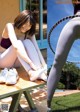 A woman sitting on a bench with a hula hoop.