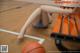 A woman laying on the floor next to a basketball.