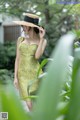 A woman in a yellow dress and a straw hat.