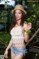 A woman in a straw hat posing for a picture.