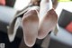 A close up of a person's feet in white tights.