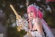 A woman with pink hair holding a sword.