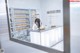 A woman sitting at a counter in a pharmacy.