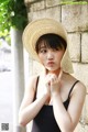 A woman in a straw hat posing for a picture.