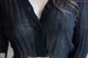 A close up of a woman wearing a black blouse.