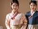 A couple of women in traditional korean clothing posing for a picture.