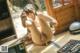 A naked woman sitting on the floor next to a television.