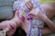 A woman laying on a bed holding a bunch of flowers.