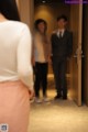 A blurry image of a man and woman standing in an elevator.