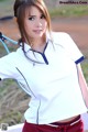 A woman holding a tennis racket on a tennis court.