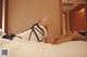 A woman laying on top of a bed in a hotel room.