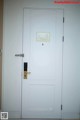 A white door with a lock on it in a room.