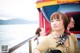 A woman sitting on a boat looking out over the water.