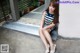 A woman sitting on the steps of a building.