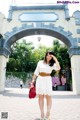 A woman standing in front of a sign that says Europe.