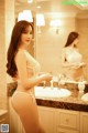 A woman in a white lingerie standing in front of a mirror.