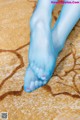 A close up of a woman's feet in blue tights.